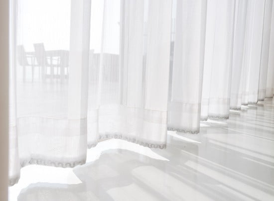 view seascape looking pass Translucent white fabric curtains and outdoor terrace, pattaya city, thailand